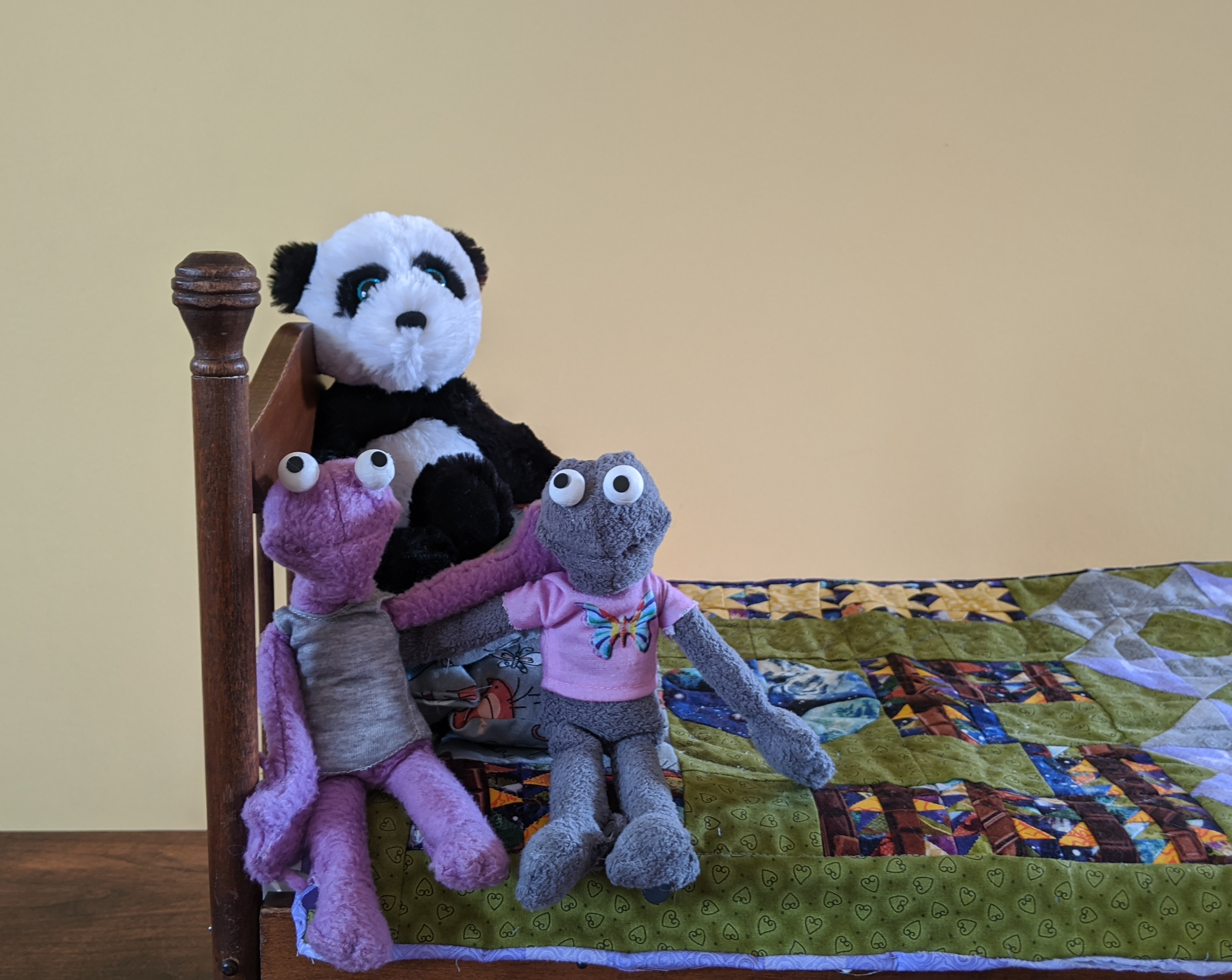 Pin and Jab and Bear sitting on their new quilt